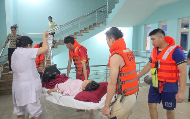 Lực lượng chức năng và nhân viên y tế đang di dời bệnh nhân tại BV Trung ương Huế ra khỏi khu vực ngập lụt